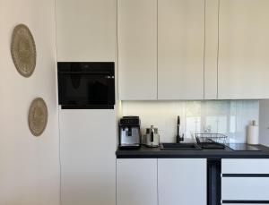 Kuchyň nebo kuchyňský kout v ubytování Sunset Resort, M3 Grzybowo