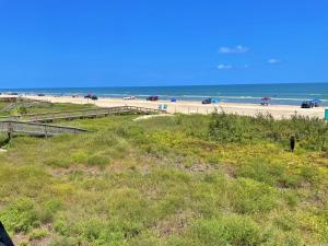 a view of a beach with cars parked on it at The Aloha Beach in Surfside Beach +31 photos