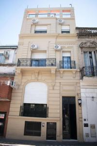 a tall building with two balconies on top of it at Habitaciones Temporarias CABA in Buenos Aires