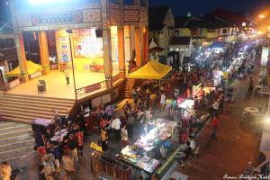 a crowd of people walking around a market at night at Fomecs Boutique Hotel in Melaka
