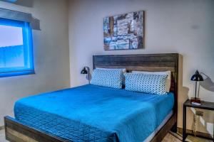 a bedroom with a bed with blue sheets and a window at Casa Azul F2 in Puerto Peñasco