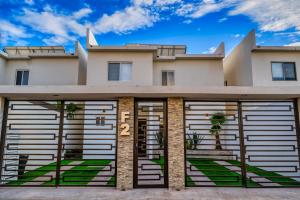 a house with two garage doors in front of it at Casa Azul F2 in Puerto Peñasco