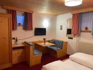 オルティゼーイにあるHotel Fortunaのベッドルーム1室(デスク、椅子付)