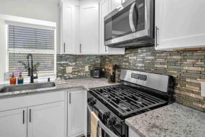 a kitchen with a stove and a microwave at Modern Base - Lackland Delight in San Antonio