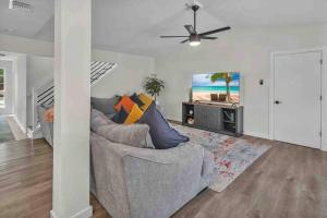 a living room with a couch and a ceiling fan at Modern Base - Lackland Delight in San Antonio