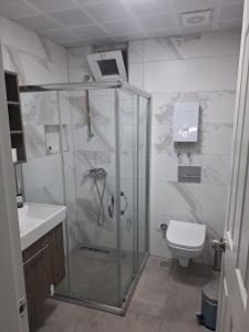 a bathroom with a shower and a toilet at Emir Hotel Belek in Serik