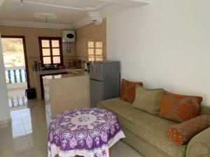 a living room with a couch and a kitchen at Taghazout waves 2 in Taghazout