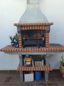 a brick oven sitting on a shelf with plants at Villa Feliza in Güime