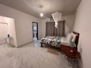 1 dormitorio con 1 cama en una habitación con suelo de mármol en Kasuba Apartments, en Livingstone
