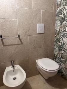 a bathroom with a toilet and a sink at L'Antica Dimora in Centro in Bari