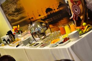 a table with a buffet of food on it at Plaza Real Hotel in Encalada