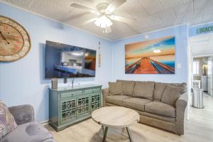 a living room with a couch and a tv at Cozy Ocean City Condo Steps to Maryland Beach! in Ocean City