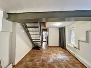 an empty hallway with a staircase in a house at Appartement Isle-sur-la-Sorgue in LʼIsle-sur-la-Sorgue