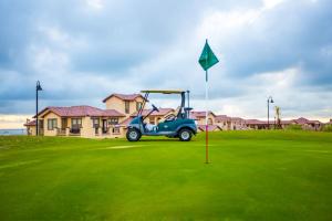 a golf cart on a green with a flag at San Felipe Beach Rental Condo 71-2 in San Felipe