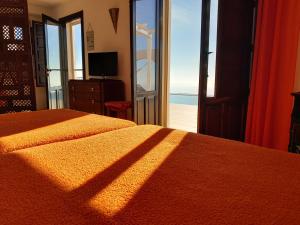 a bedroom with a bed and a view of the ocean at Cerro del Pozo in Las Hoyas del Barranco