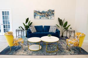 a living room with a blue couch and chairs at Rodeway Inn Clearwater - Central in Clearwater