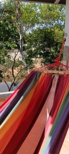 a rainbow colored hammock with trees in the background at Casa Blanca 