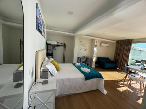 a bedroom with a bed and a living room at Madeira Sea Sunshine with heated pool in Ribeira Brava