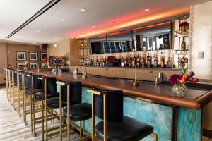 a bar with a row of bar stools at Artezen Hotel in New York