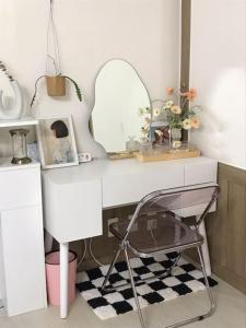 a bathroom with a desk with a mirror and a chair at Cottenbeach2 in Sokcho