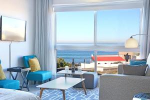 a living room with a view of the ocean at Blouberg Heights 202 by HostAgents in Bloubergstrand
