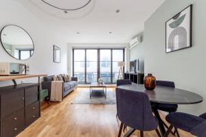 a living room with a table and a couch at The Camden Collection in London