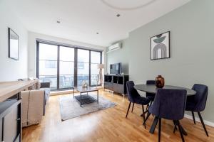 a kitchen and living room with a table and chairs at The Camden Collection in London