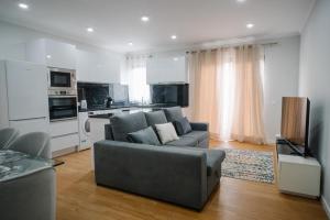 a living room with a couch and a kitchen at casa são lourenço in Caniçal