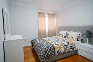 a bedroom with a bed and a window and a nightstand at casa são lourenço in Caniçal +3 photos
