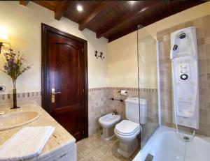 a bathroom with a toilet and a shower and a sink at El Valle Hotel Rural in Sotillo del Rincón +124 photos