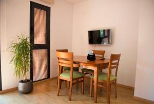 a dining room with a wooden table and chairs at Vipimmoble ! in Guardiola de Berguedà