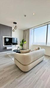 a living room with a couch and a table at Best Spacious Studio at Sky Gardens DIFC in Dubai