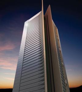 un edificio blanco alto con una puesta de sol en el fondo en Best Spacious Studio at Sky Gardens DIFC, en Dubái