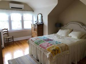 a bedroom with a bed with a mirror and a dresser at NEW! Apartment in Historic Mansion. Location! Views! in Denver