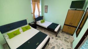 Postel nebo postele na pokoji v ubytování Hotel El Bosque
