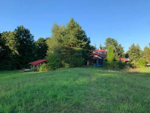 a view of the house from the field at Agroturystyka Kalwiszki in Sejny