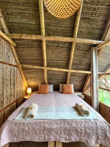 a room with a bed in a thatched room at Tierra Alta, Refugio de Montaña, Sauce in Sauce