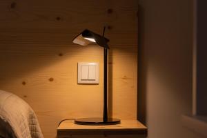 a lamp sitting on a table next to a bed at Quinta Do Crestelo Aparthotel in Seia