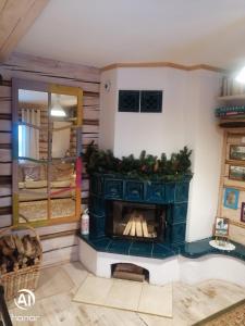 a fireplace in a living room with a christmas centerpiece at Chatka Koniaków 7 in Koniaków
