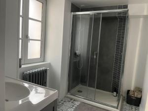 a bathroom with a shower with a sink and a tub at La Har'Elle in Château-Gontier