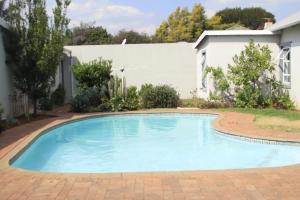 a swimming pool in the yard of a house at East Prestige lodge in Johannesburg