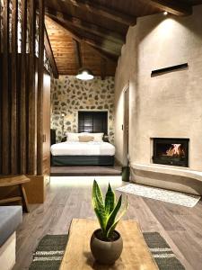 a living room with a bed and a fireplace at Bocca al Lupo Villas in Kato Loutraki