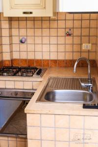 a kitchen with a sink and a stove at Villette Calliope in Torre Specchia Ruggeri +47 photos