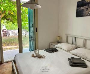 a bedroom with a bed with a stuffed animal on it at Villette Calliope in Torre Specchia Ruggeri