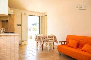 a living room with a couch and a table at Villette Calliope in Torre Specchia Ruggeri