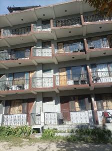 an apartment building with balconies on the side of it at Asha Residency Shimla - Airport Road in Shimla