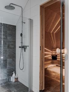 a bathroom with a shower with a glass door at Åre Valley Lodges - Ytterstmyrvägen 19D in Åre