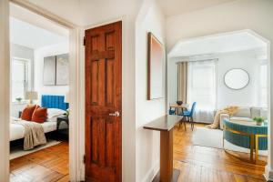 a room with a door and a bedroom with a bed at 61-2C Prime UES 2BR Newly furnished best value in New York