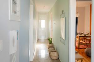 a room with a hallway with a table and chairs at Casa 8 - Two Bedroom House in Patras in Patra