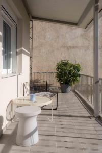 a balcony with a table and chairs on a building at Casa 8 - Two Bedroom House in Patras in Patra